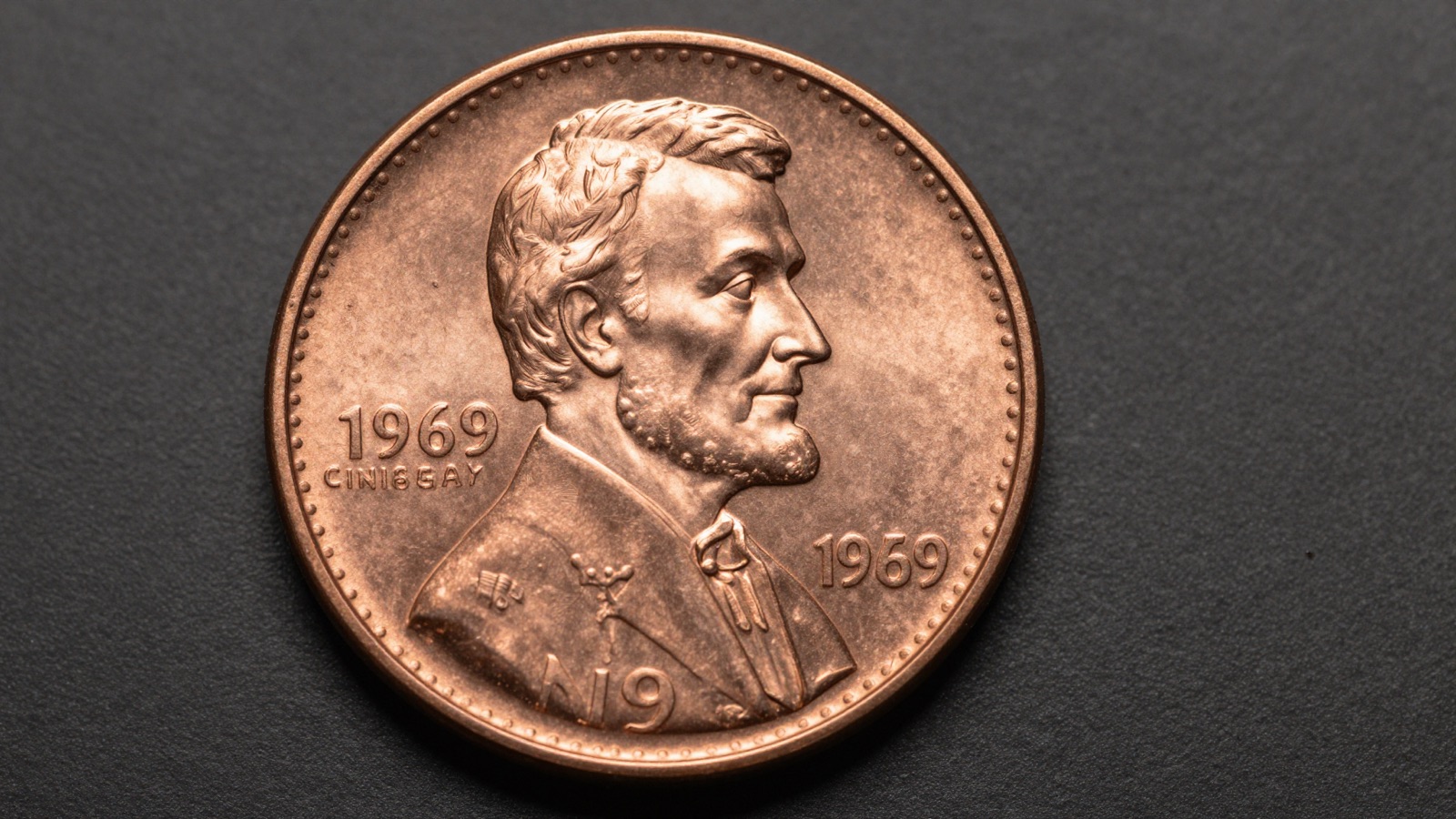 Close-up macro photograph of a 1969-S doubled die obverse Lincoln cent showing bold inscription doubling