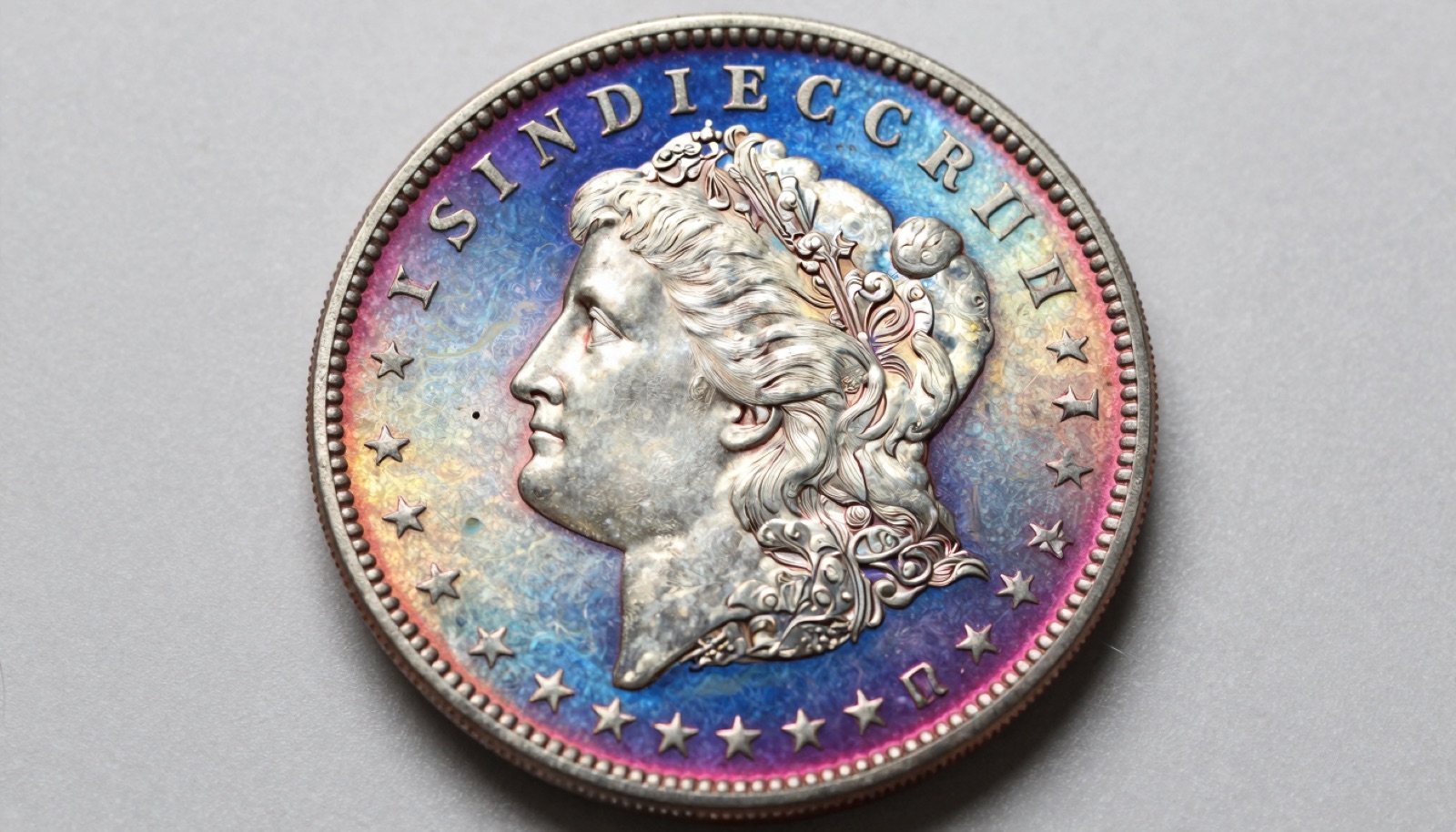 Rainbow toned Morgan silver dollar showing concentric blue magenta and gold oxidation color bands on reverse