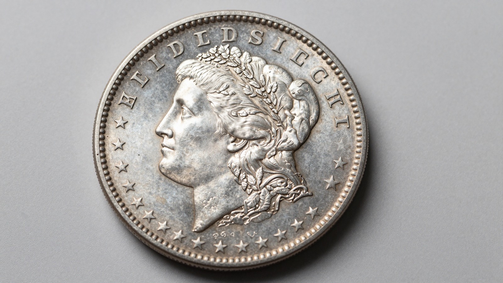 Rare Morgan silver dollar displayed on a neutral studio surface under professional numismatic lighting for identification